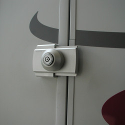 Universal surface-mounted lock for trunk lids